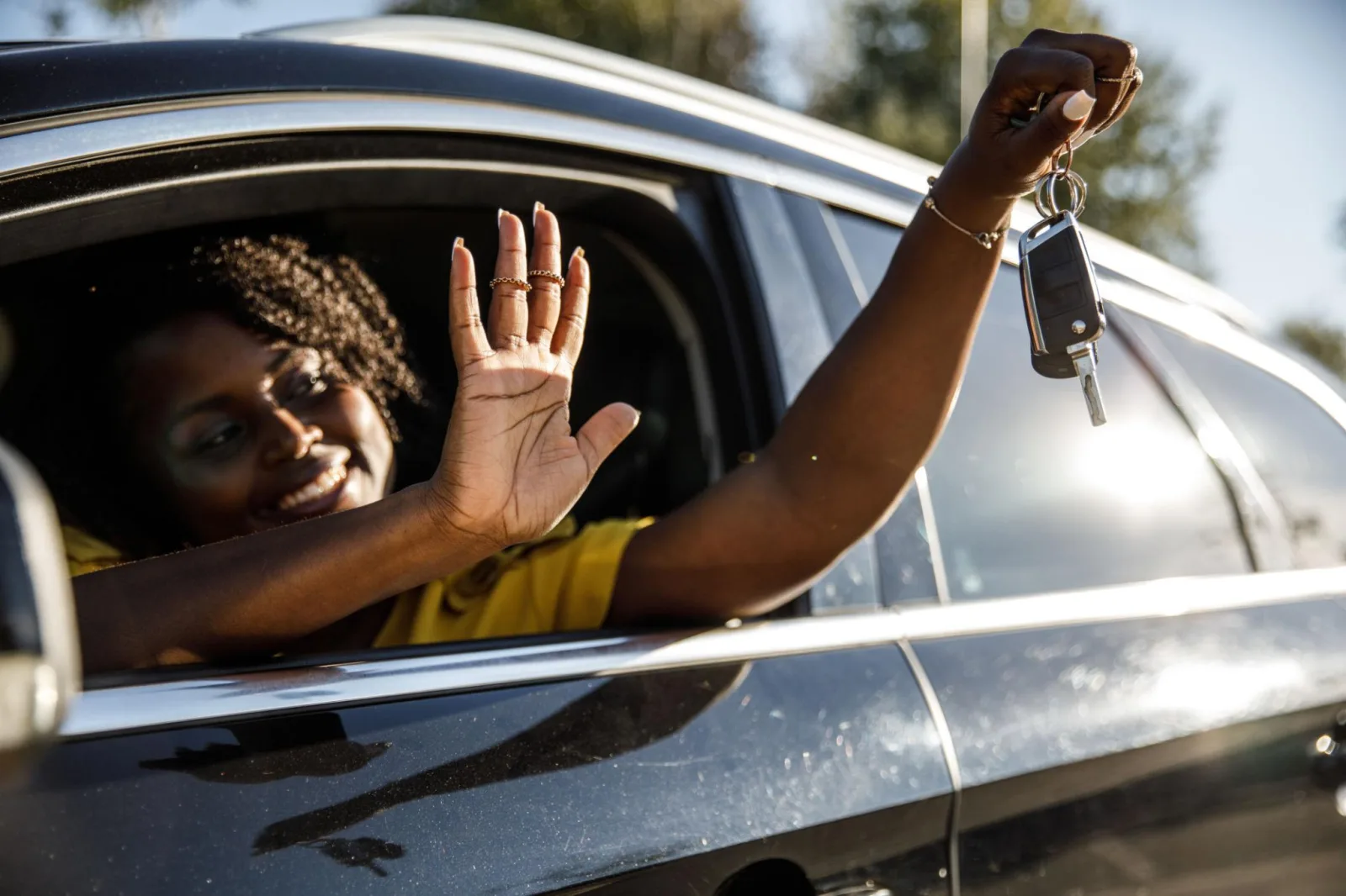 Buyer holding their new car keys, ready to drive off